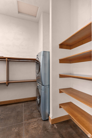 2464 East Granite Way St. George, UT 84790 - Photo 36 of 106 Primary closet with laundry area with finished concrete flooring, stacked washer and dryer, and a textured wall