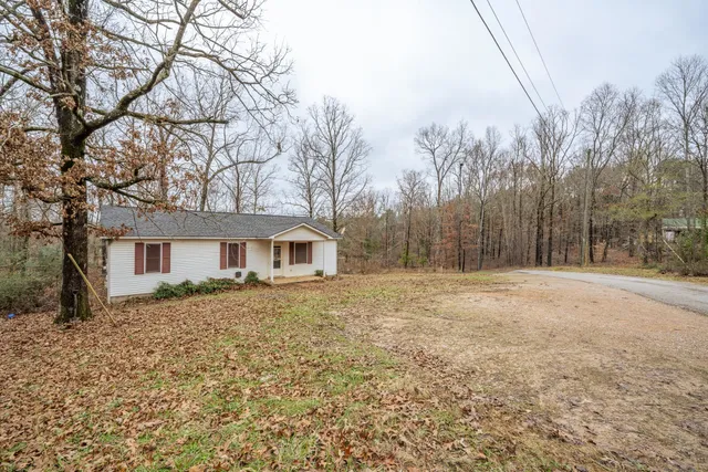 a view of a house with a bed and trees