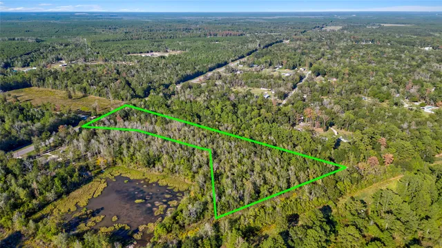 an aerial view of a houses with a yard