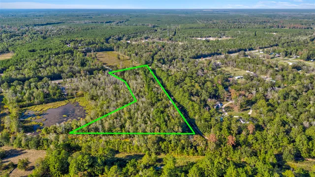 an aerial view of a houses with a yard