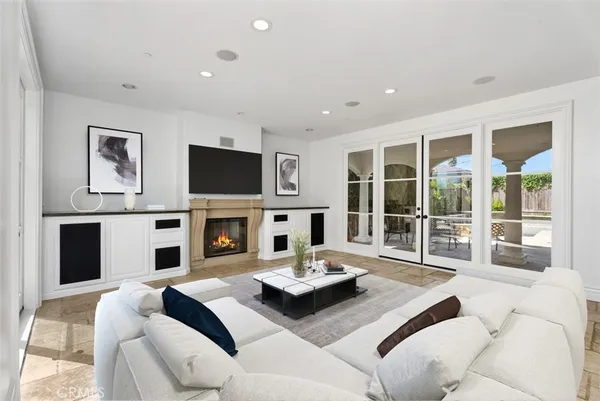a living room with furniture a fireplace and a large window