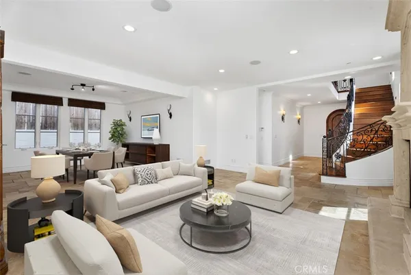 a living room with furniture and view of kitchen