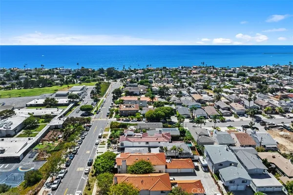 an aerial view of a houses with a swimming pool