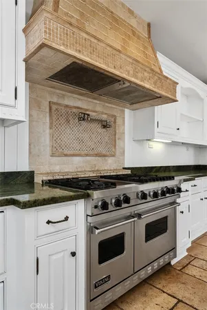 a stove top oven sitting inside of a kitchen