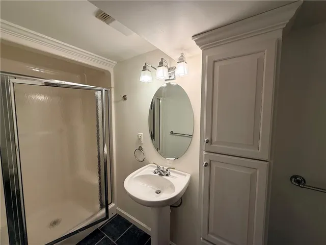 a bathroom with a sink a mirror and a shower