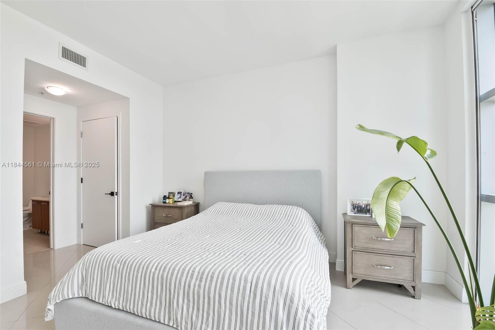 3301 Northeast 1st Avenue, Unit H1211 Miami, FL 33137 - Photo 11 of 37 a bedroom with a bed and sliding window