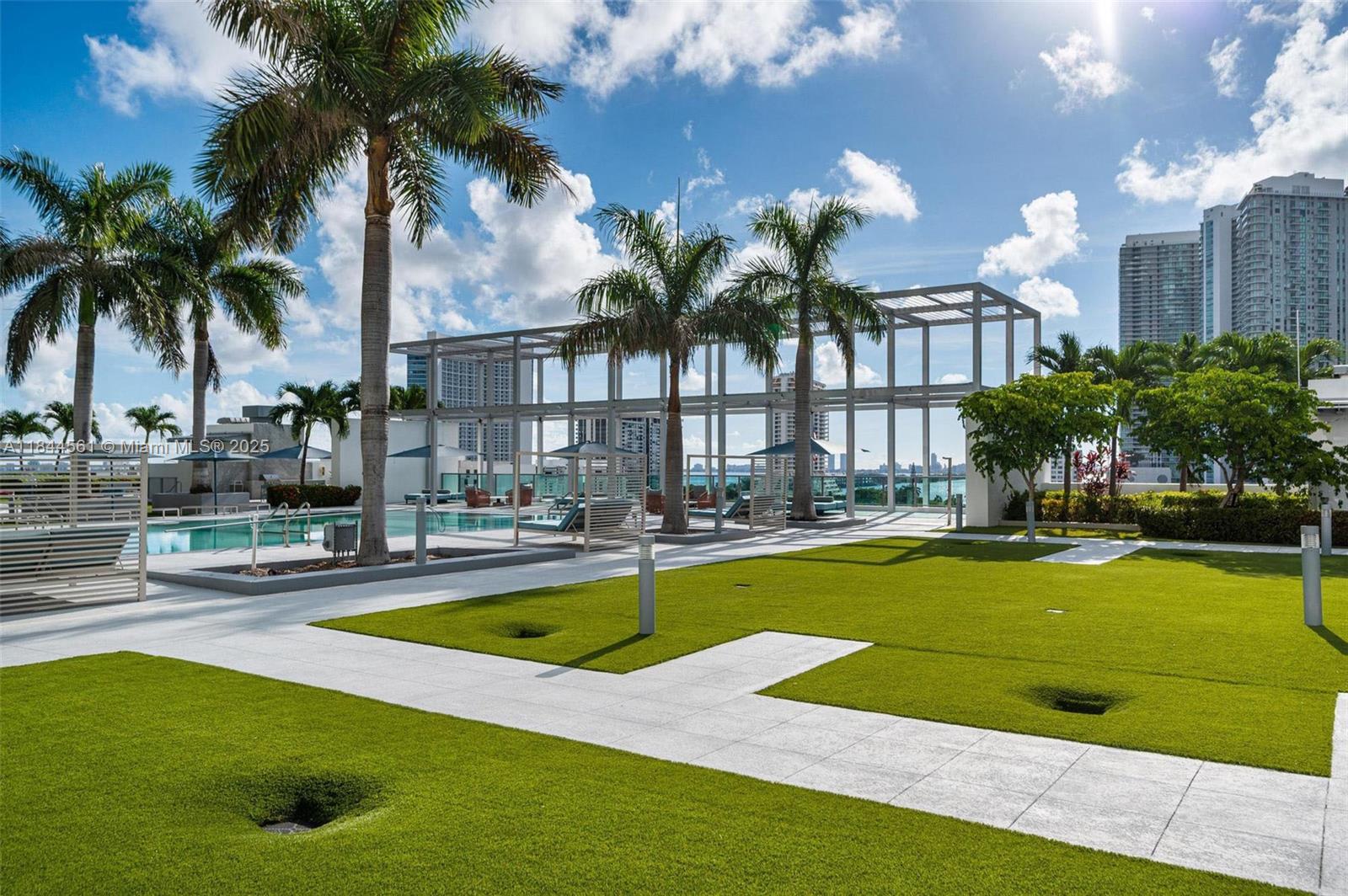 3301 Northeast 1st Avenue, Unit H1211 Miami, FL 33137 - Photo 27 of 37 a swimming pool with outdoor seating and yard