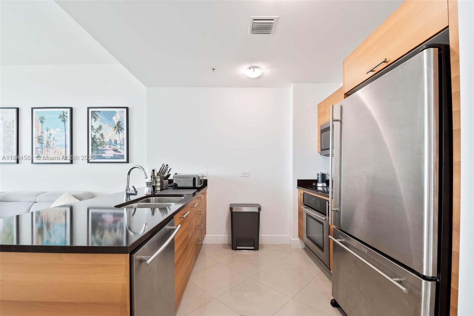 3301 Northeast 1st Avenue, Unit H1211 Miami, FL 33137 - Photo 4 of 37 a kitchen with stainless steel appliances granite countertop a refrigerator and a stove