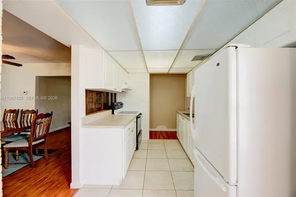 a view of a hallway with furniture and wooden floor