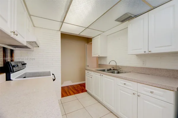 a kitchen with stainless steel appliances granite countertop a sink and cabinets