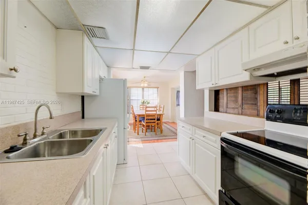 a kitchen with a sink cabinets and counter top space