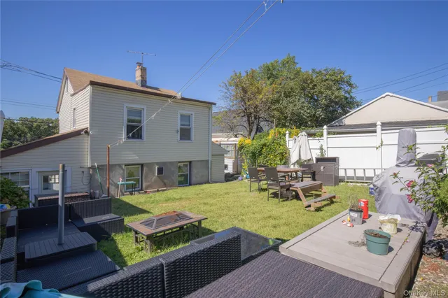 a view of an house with backyard and sitting area