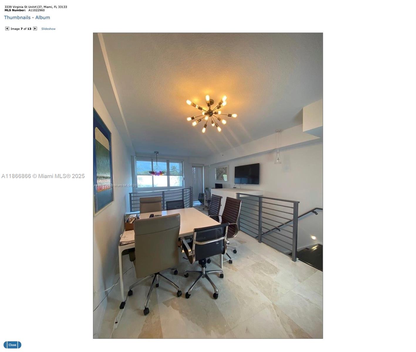 3339 Virginia Street, Unit 137 Miami, FL 33133 - Photo 10 of 11 a view of a dining room with furniture and chandelier