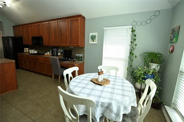 a dining room with furniture and potted plants