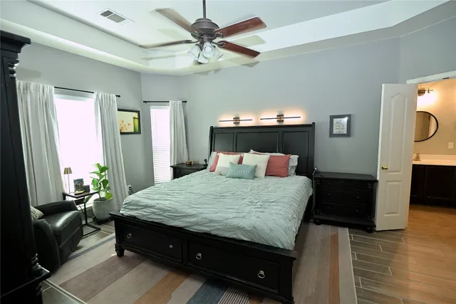 a bedroom with a bed and a chandelier