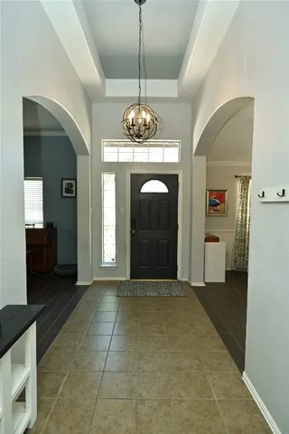 a view of a hallway with wooden floor and a kitchen