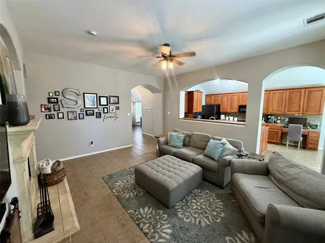 a living room with furniture a rug and a flat screen tv