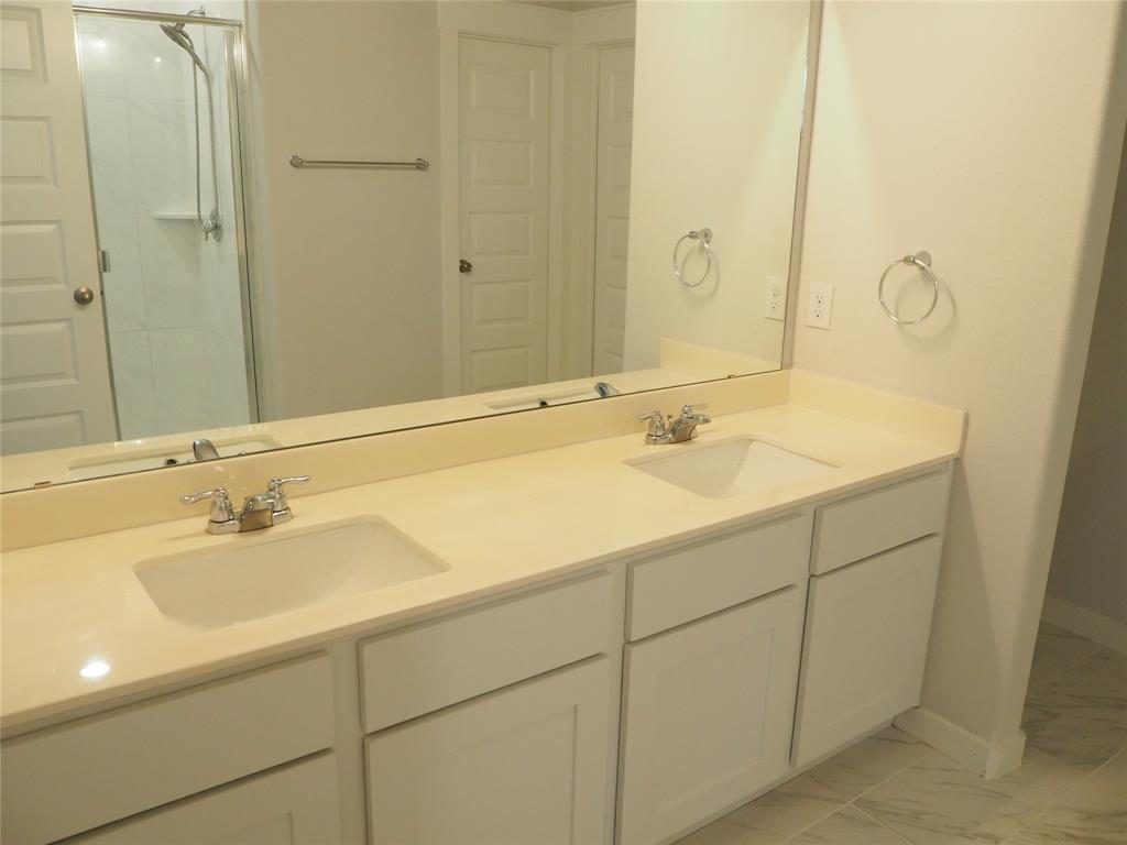 2502 Sun Grove Road Melissa, TX 75454 - Photo 16 of 40 a bathroom with a sink and a mirror