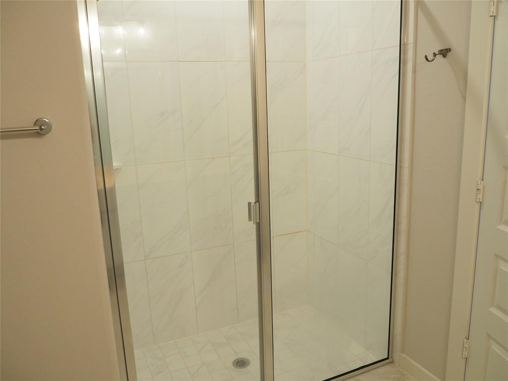 2502 Sun Grove Road Melissa, TX 75454 - Photo 17 of 40 a bathroom with a glass shower door