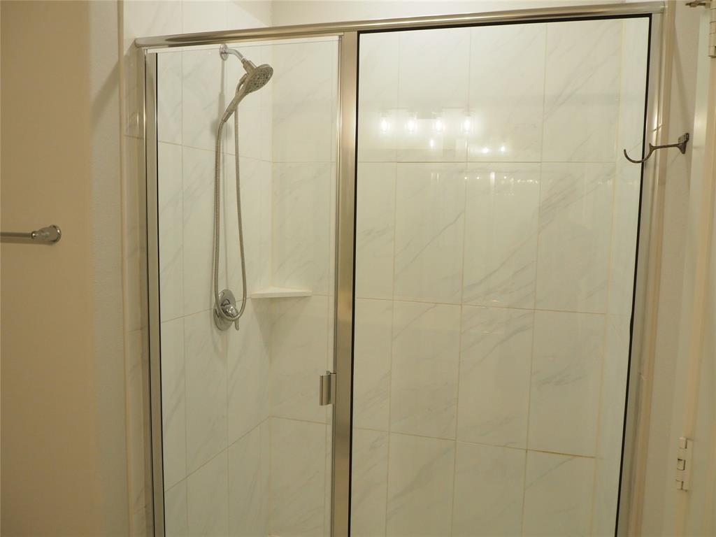2502 Sun Grove Road Melissa, TX 75454 - Photo 18 of 40 a bathroom with a glass shower door