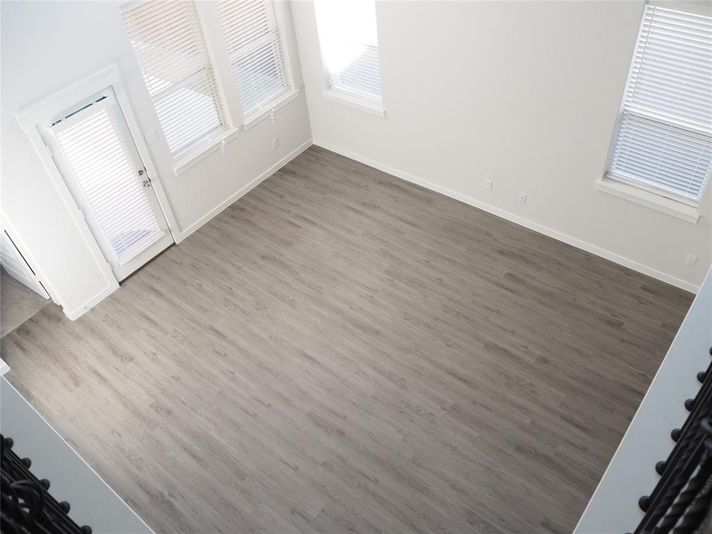 2502 Sun Grove Road Melissa, TX 75454 - Photo 31 of 40 an empty room with wooden floor and windows