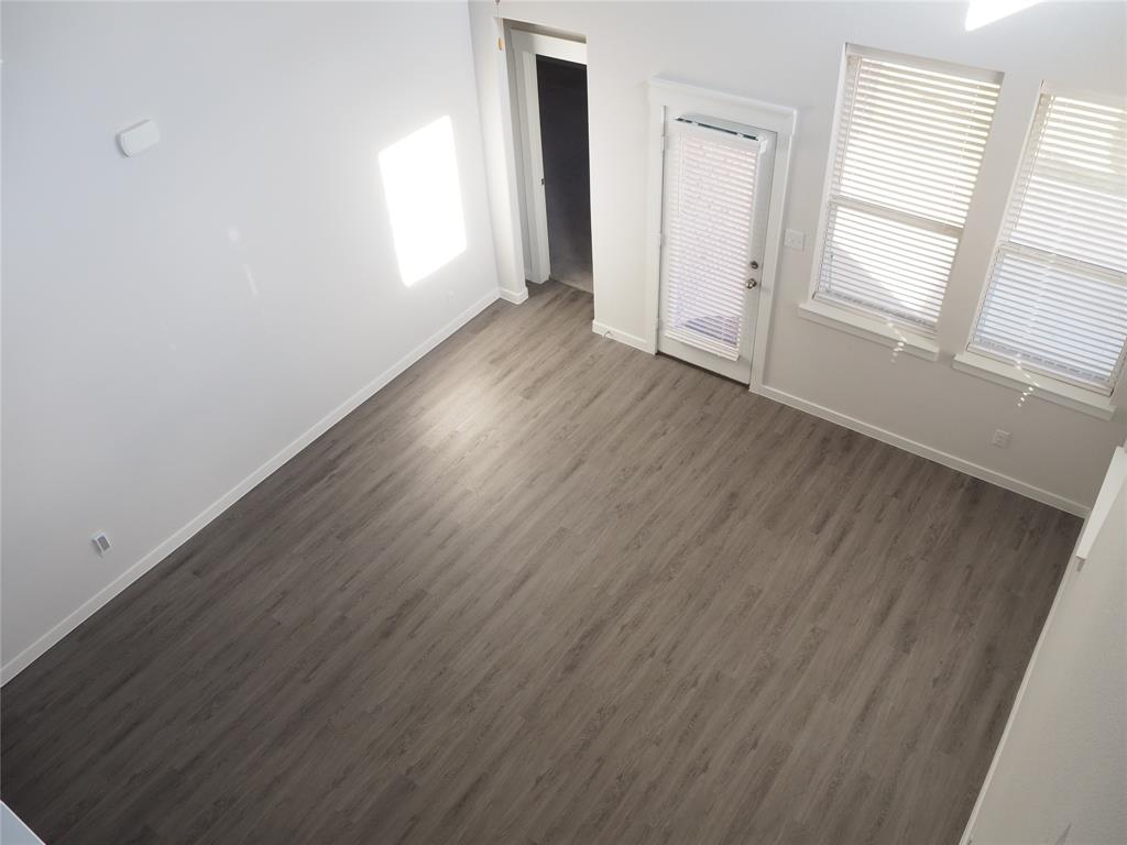 2502 Sun Grove Road Melissa, TX 75454 - Photo 32 of 40 an empty room with wooden floor and windows