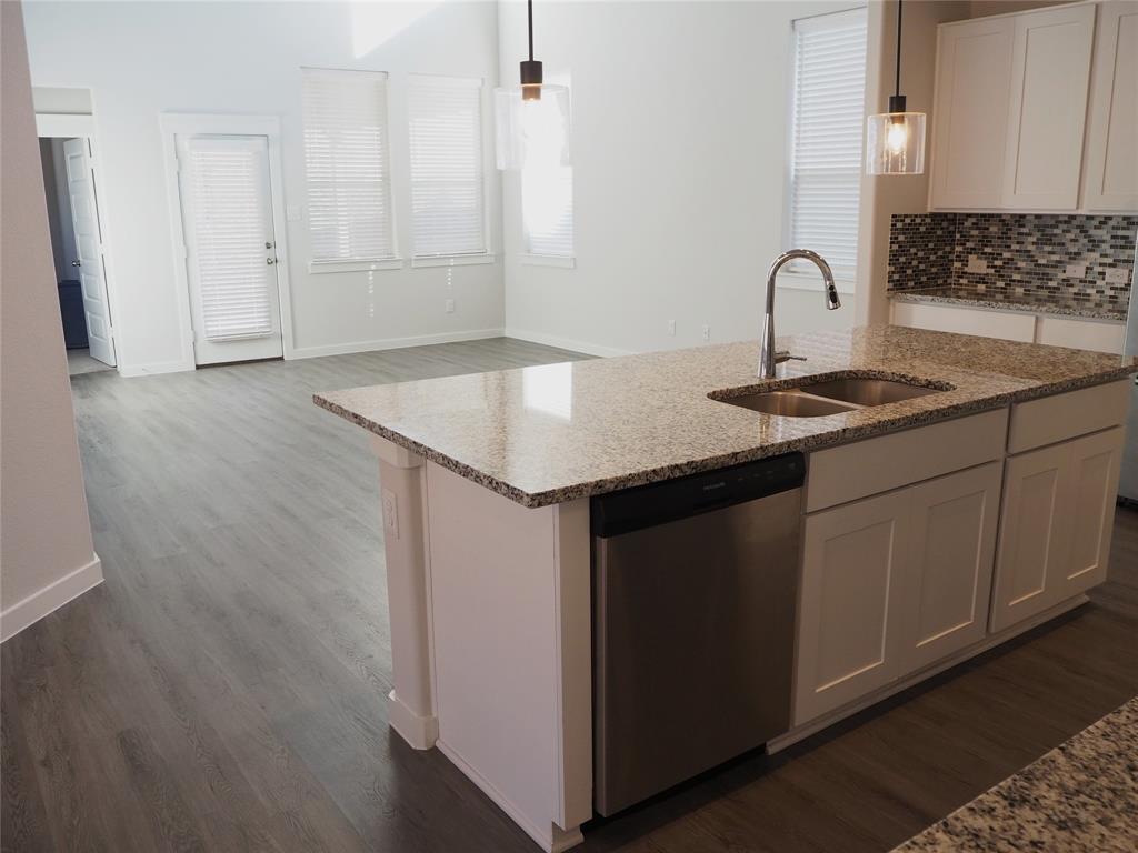 2502 Sun Grove Road Melissa, TX 75454 - Photo 5 of 40 a kitchen with a sink and cabinets