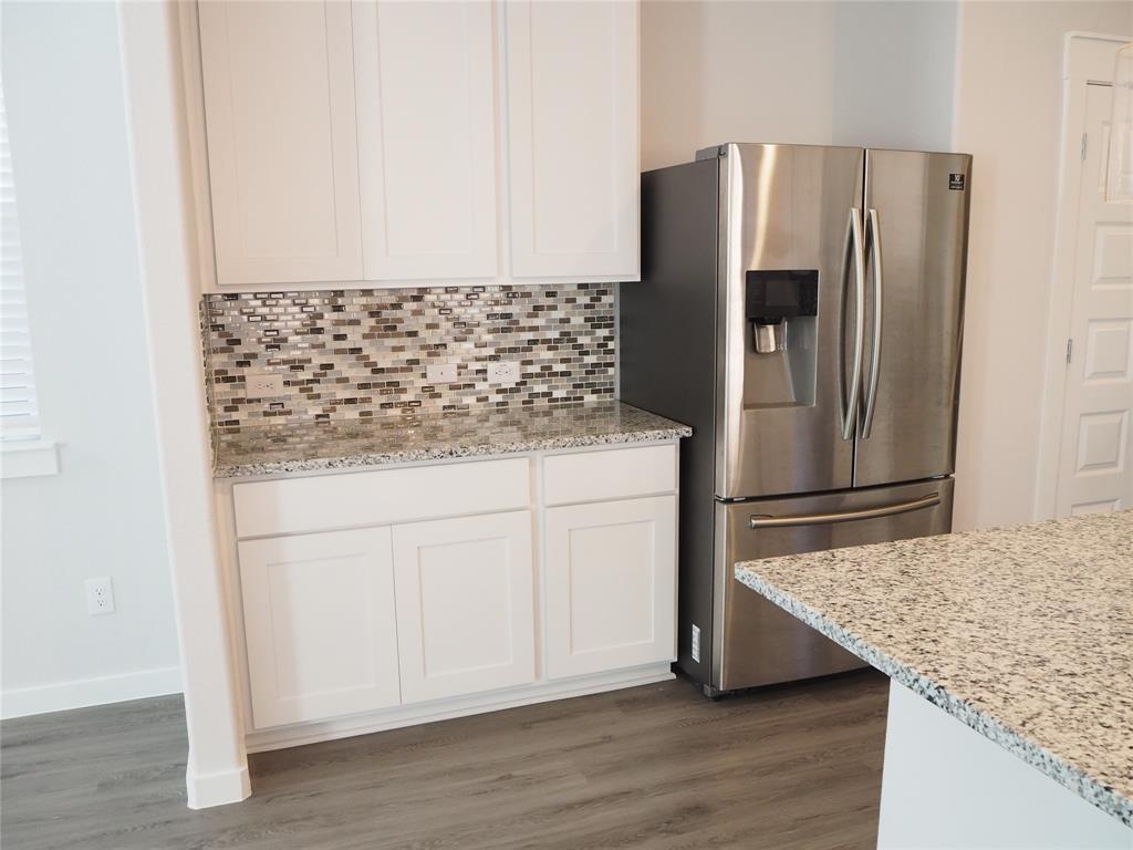 2502 Sun Grove Road Melissa, TX 75454 - Photo 9 of 40 a kitchen with stainless steel appliances granite countertop a refrigerator and a stove