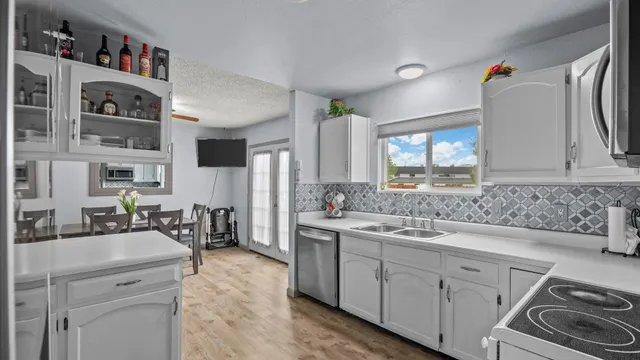 a kitchen with stainless steel appliances a sink stove and cabinets