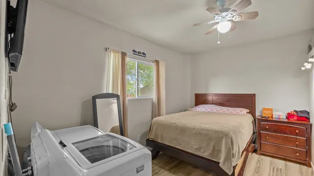 a bedroom with a bed and a chandelier