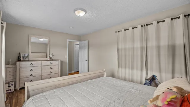 a bedroom with a bed and a dresser