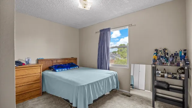 a bedroom with a bed and a window