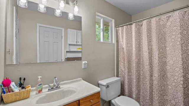 a bathroom with a sink toilet and shower