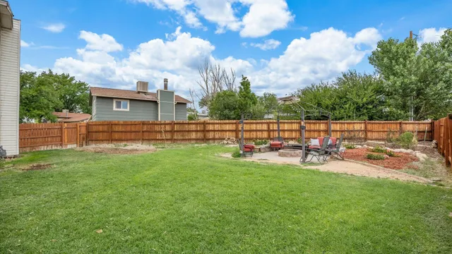 a view of a yard with table and chairs and a fire pit