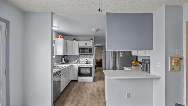 a kitchen with cabinets and stainless steel appliances