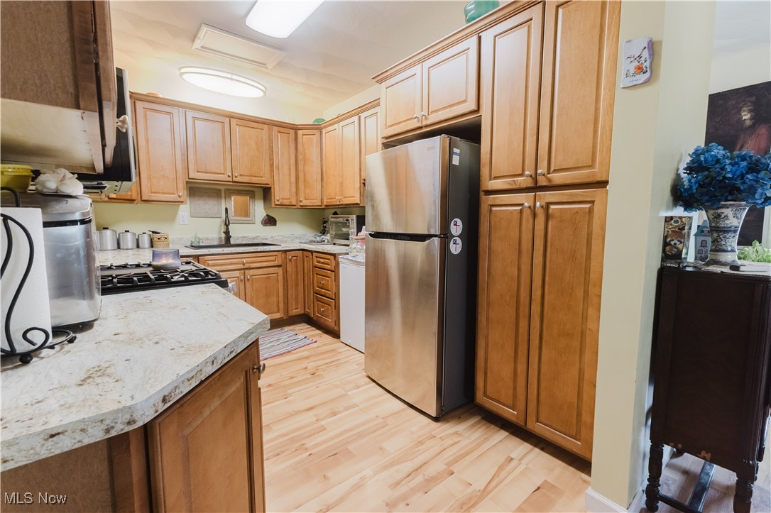 857 Archer Hill Road Colliers, WV 26035 - Photo 11 of 37 Kitchen featuring freestanding refrigerator, light countertops, and light wood finished floors