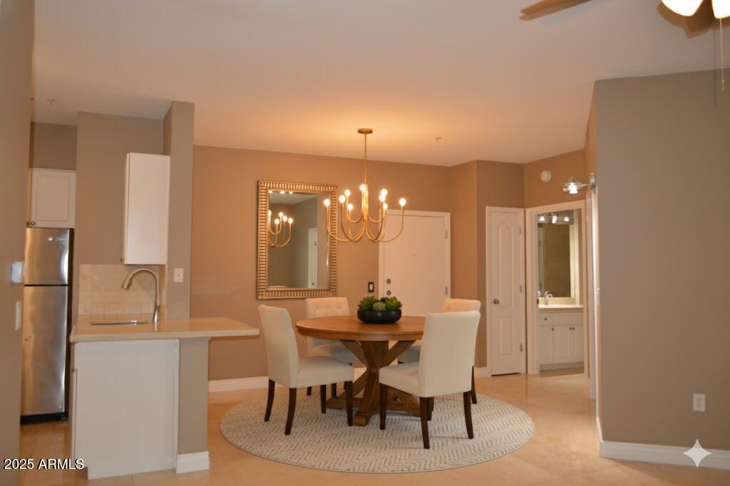 a view of a dining room with furniture and chandelier