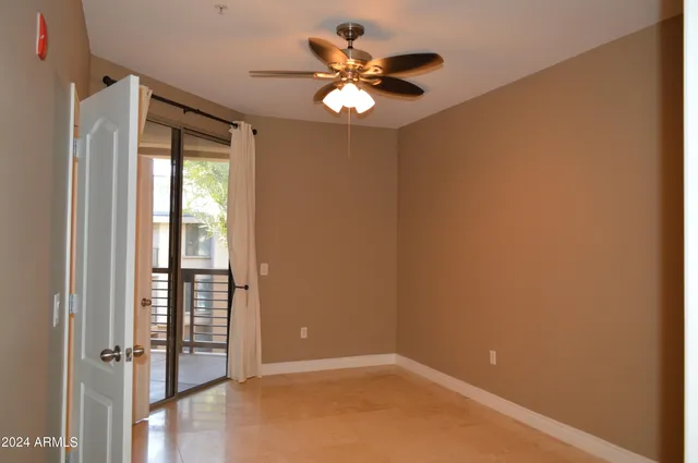 a view of a hallway with dining room and chandelier