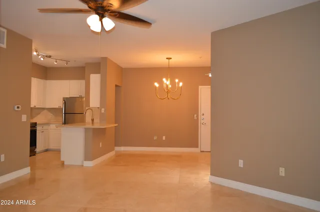 a view of a kitchen with a sink and a refrigerator