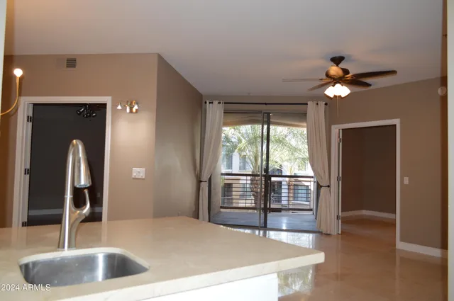 a kitchen with kitchen island a sink stainless steel appliances and a counter top space