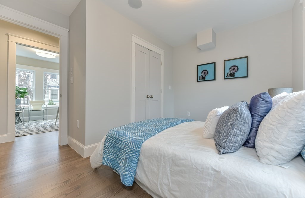 34 Rossmore Road, Unit ONE Boston, MA 02130 - Photo 13 of 21 a bedroom with a bed and a view of bathroom