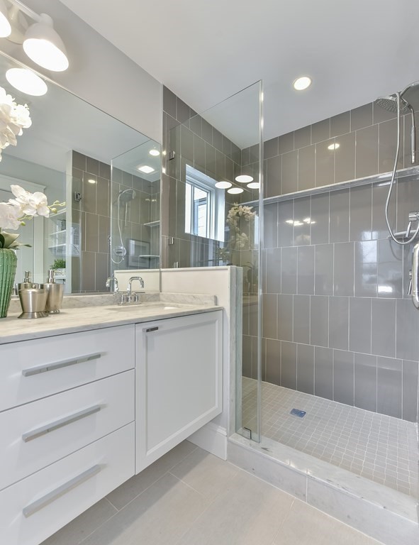 34 Rossmore Road, Unit ONE Boston, MA 02130 - Photo 19 of 21 a bathroom with a shower sink and mirror