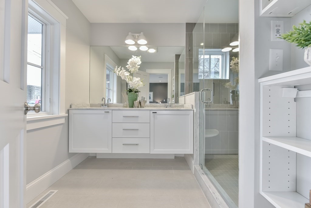 34 Rossmore Road, Unit ONE Boston, MA 02130 - Photo 21 of 21 a bathroom with a sink a large mirror and a shower