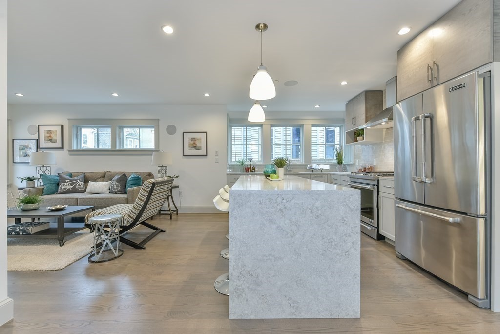 34 Rossmore Road, Unit ONE Boston, MA 02130 - Photo 5 of 21 a kitchen with stainless steel appliances granite countertop a refrigerator dining table and chairs