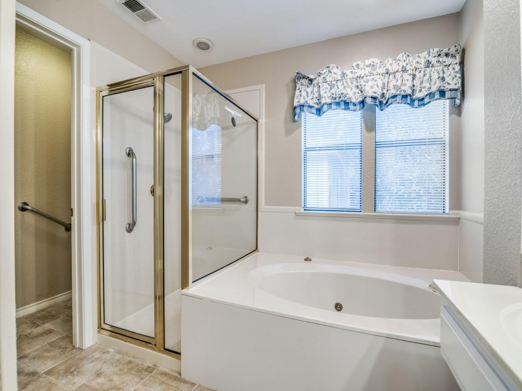 9981 Waterfront Trail Rowlett, TX 75087 - Photo 22 of 26 a bathroom with a tub a mirror and a shower