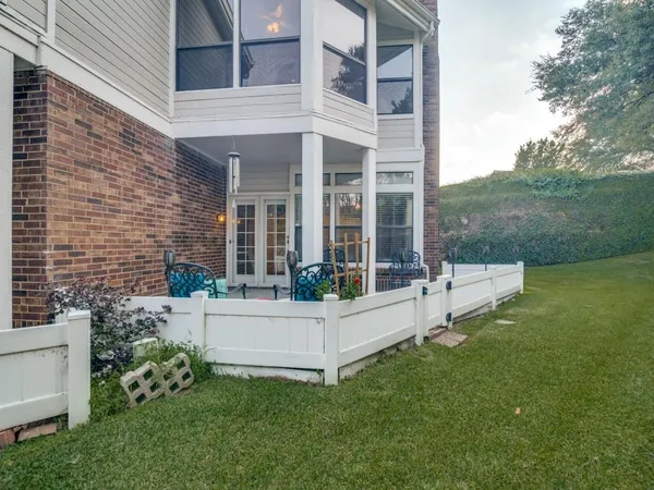 a view of a house with backyard sitting area and garden