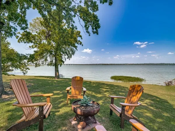 a view of a ocean with outdoor seating space