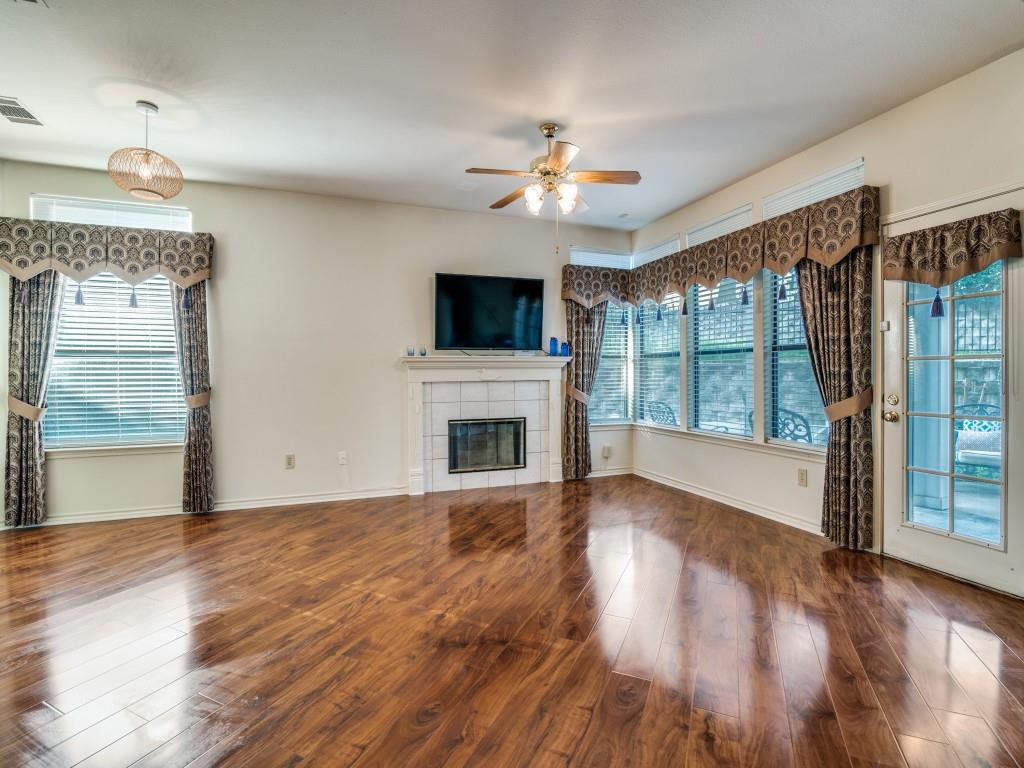9981 Waterfront Trail Rowlett, TX 75087 - Photo 5 of 26 a view of an empty room with wooden floor and a fireplace
