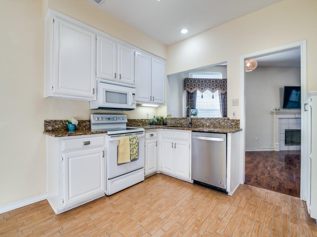 9981 Waterfront Trail Rowlett, TX 75087 - Photo 8 of 26 a kitchen with granite countertop white cabinets and white appliances