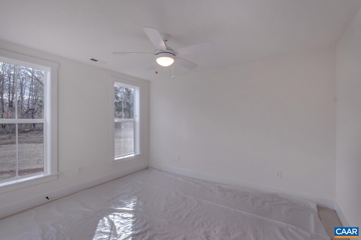 2 Jarmans Gap Road, Unit LOT 2 JARMANS GAP Crozet, VA 22932 - Photo 30 of 48 an empty room with windows and chandelier fan